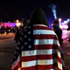 A protester wraps himself in a U.S. flag in Ferguson, Mo., Nov. 25, 2014, during demonstrations a day after violent protests and looting following the grand jury decision in the fatal shooting of 18-year-old black teenager Michael Brown.
JEWEL SAMAD/AFP/Getty Images